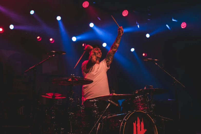 a man with his arms up on stage