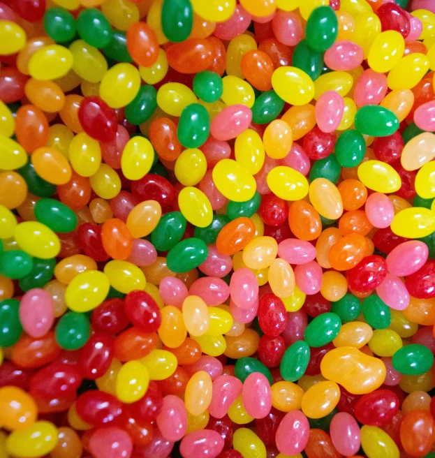 lots of gummy bears are scattered in a bowl