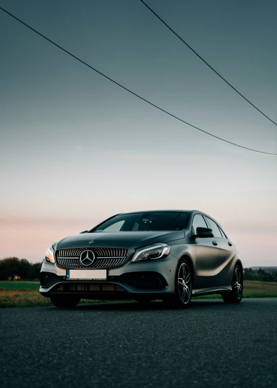 a mercedes - benz s - class coupe driving down the road at sunset