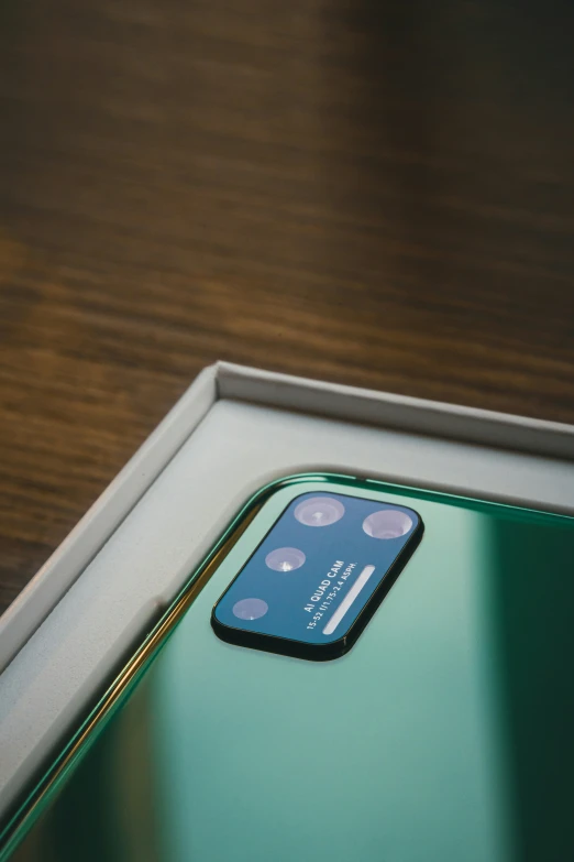 a small apple iphone with a blue back panel in its display case