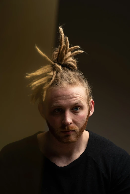 man with mohawk undercut, black shirt and dark t - shirt