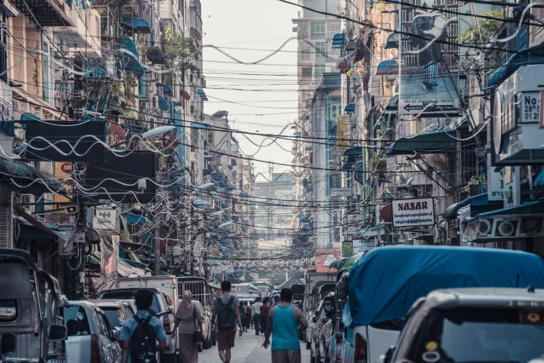 a street view of people on the side walk in a city