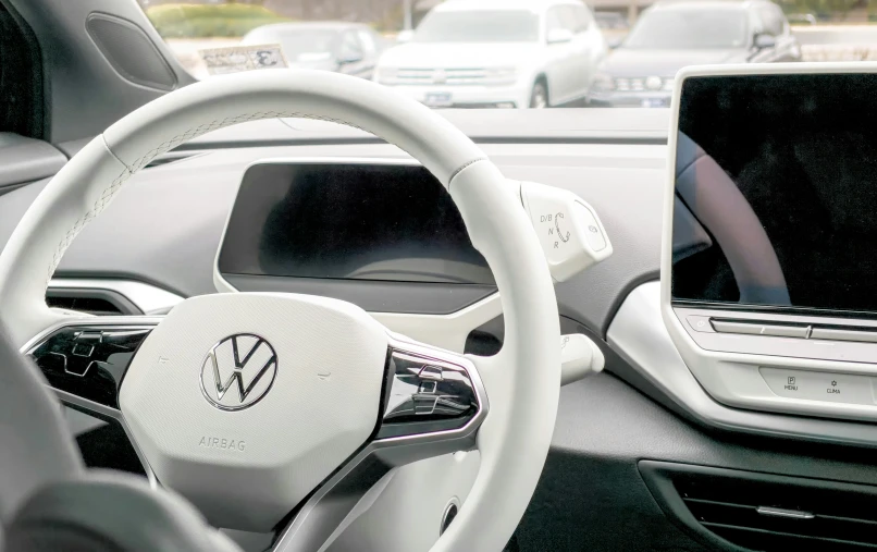 the inside of a vw car with a dashboard and monitor
