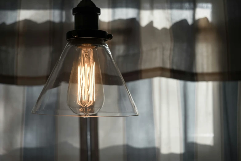 a light bulb with a glass cover on a window