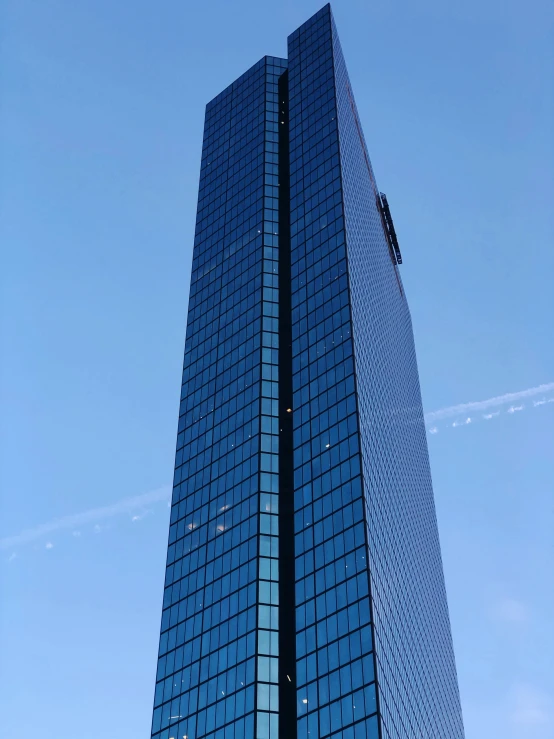 there is a tall building that has been reflected in the glass