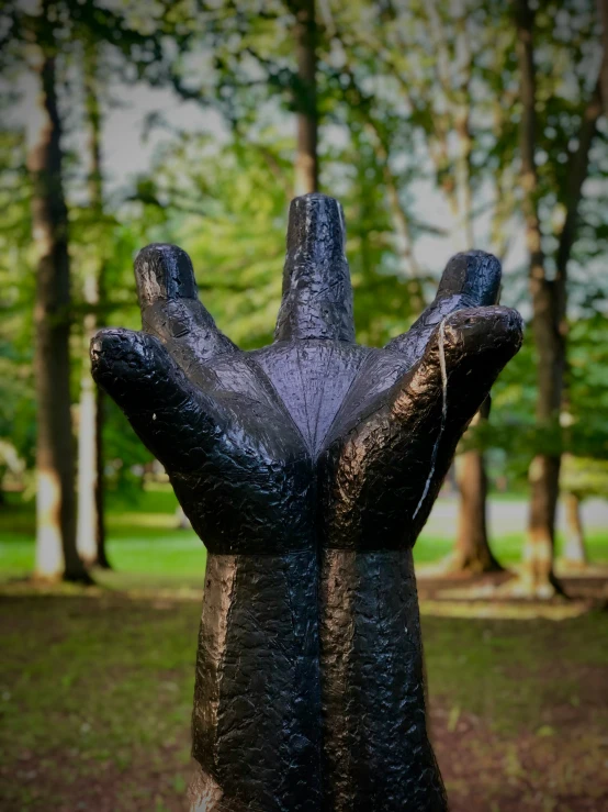 a statue made to look like a hand sticking out from the ground