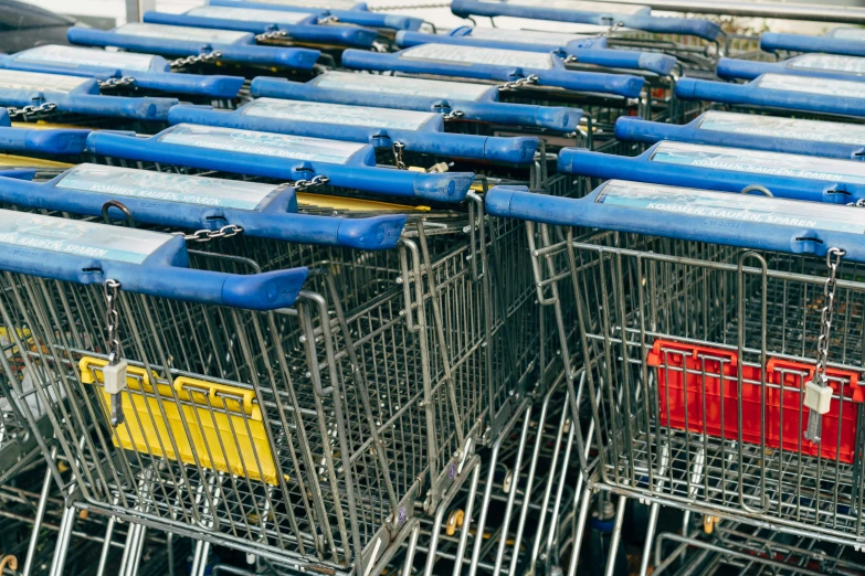 several empty shopping carts stacked close together in an auction