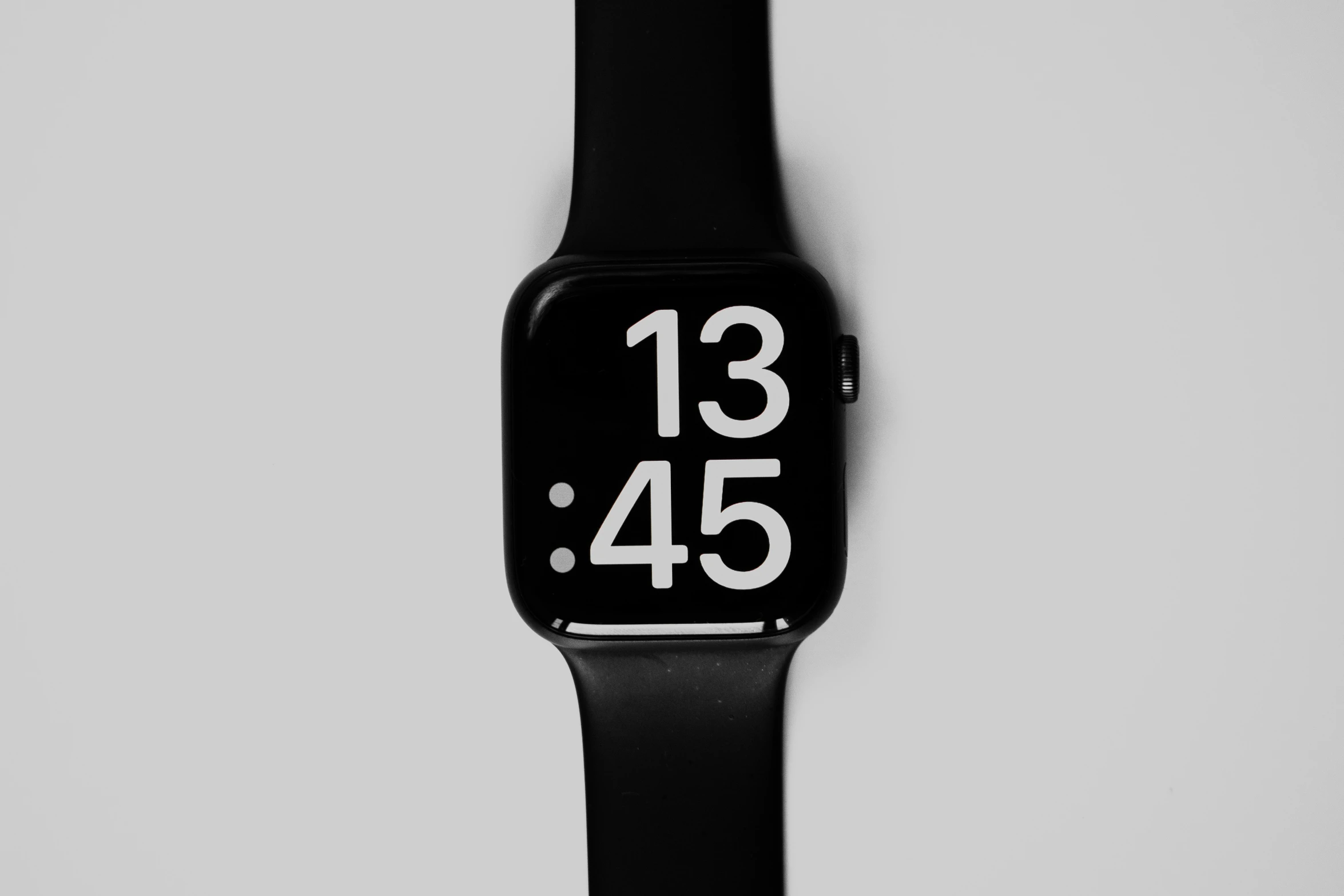 a black and white watch on a gray background