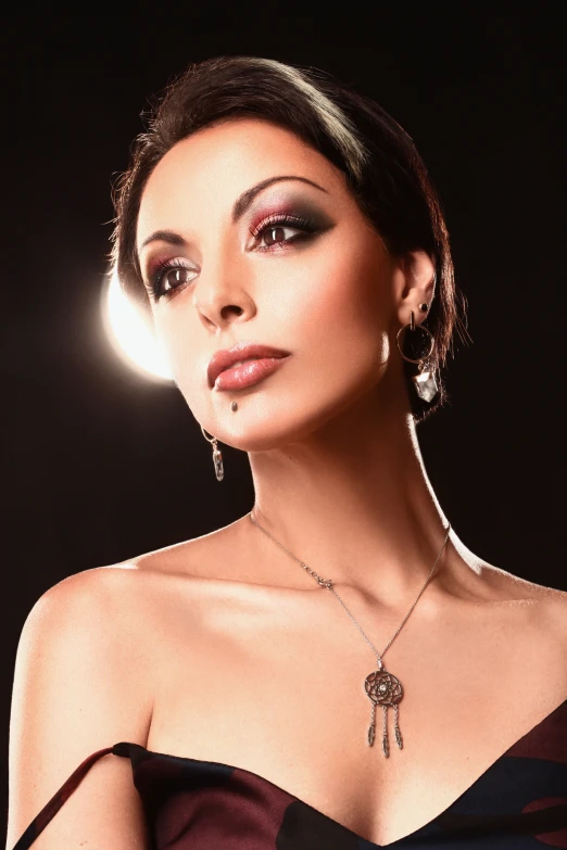 a woman is wearing a dress with an intricate necklace and a flower shaped brooch