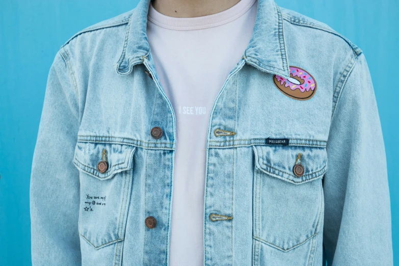 a woman with a donut on her jacket