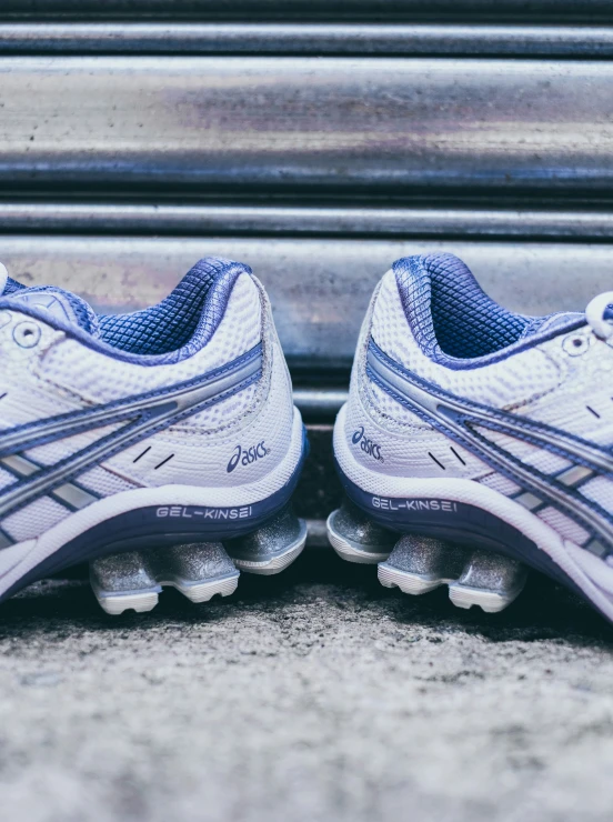 two pairs of blue and white running shoes