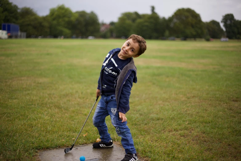 a  stands in the rain playing with a toy