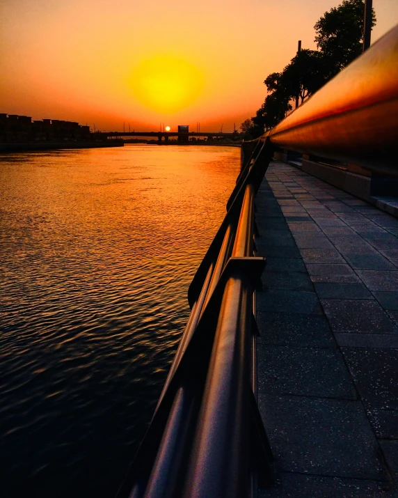 a view from the side of a river at sunset