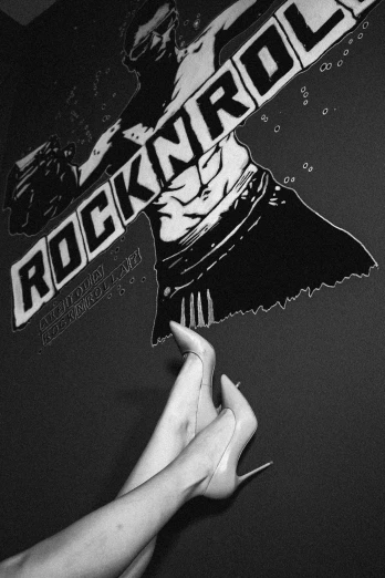 a black and white image of someone holding up a sticker