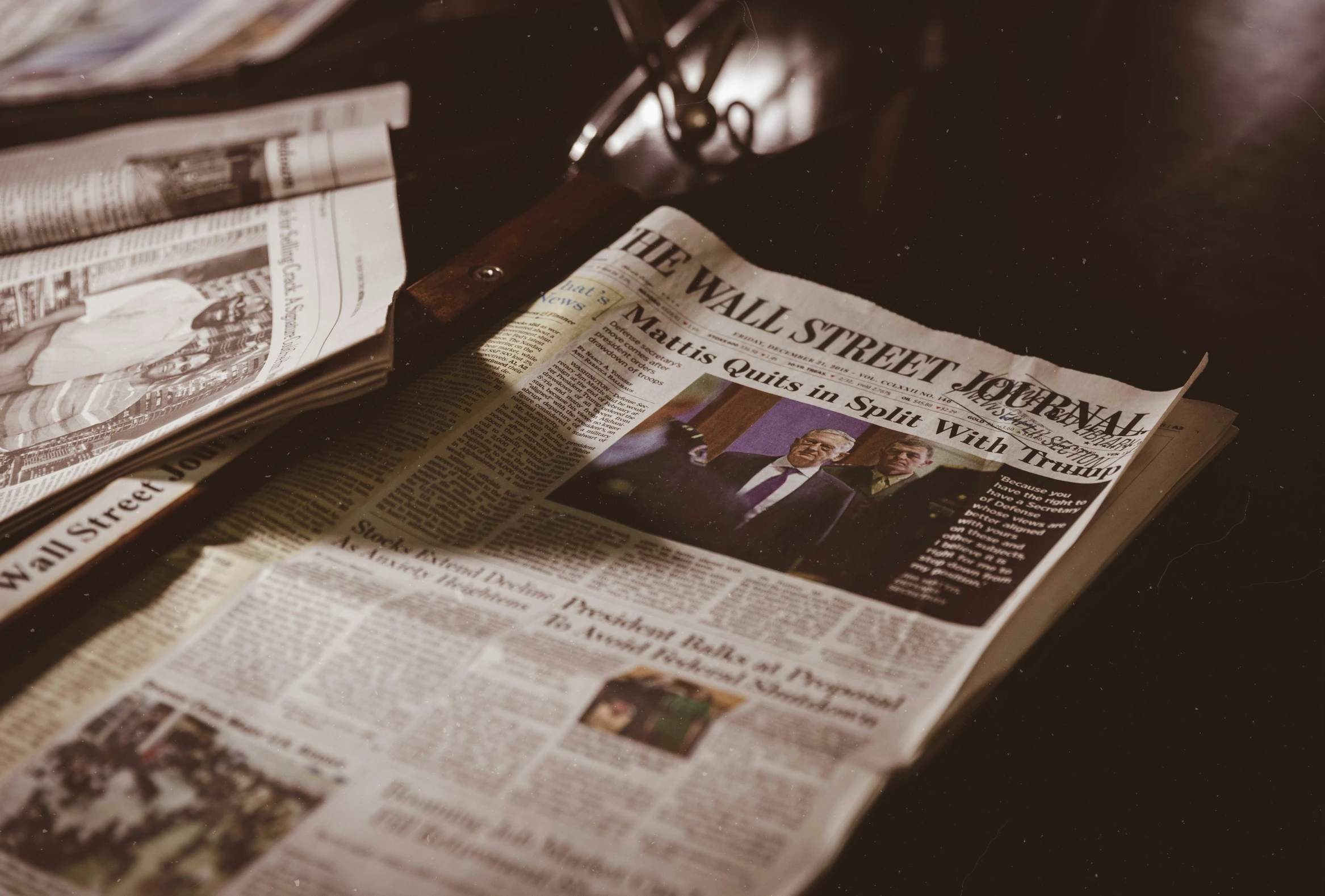 two newspapers sit on the table next to each other