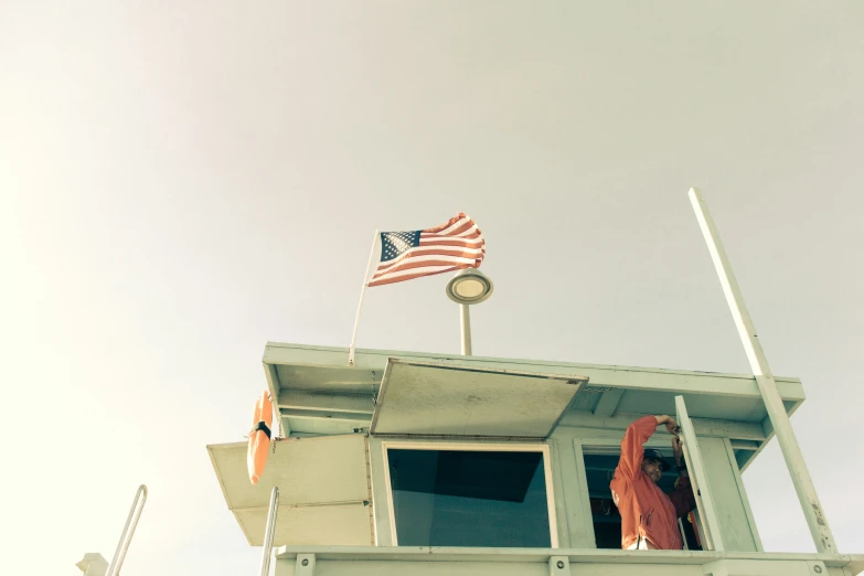 a red white and blue american flag on top of a building