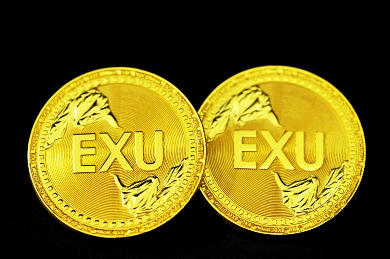 a close up of two gold coin in front of a black background