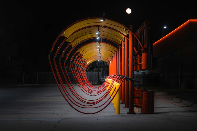 red metal tubes are lined up along the wall