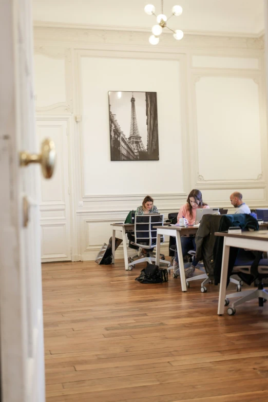 people are using laptops in a wood floored area