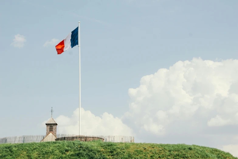 a flag flying on the side of a hill