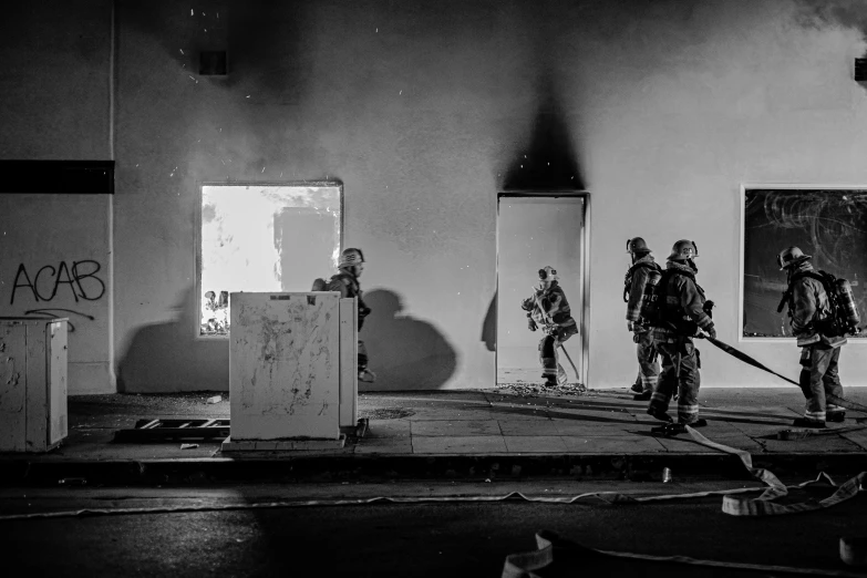 men with fire uniforms standing around in a building