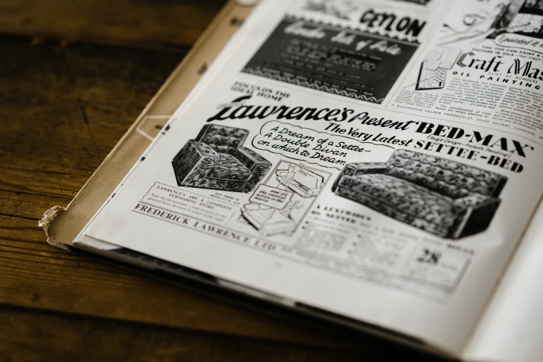the pages of a newspaper are spread on wood