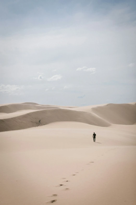 lone person walking in the middle of a vast expanse