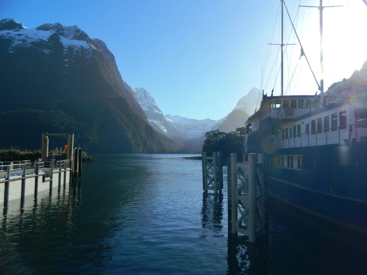 a large boat sitting at the end of a pier