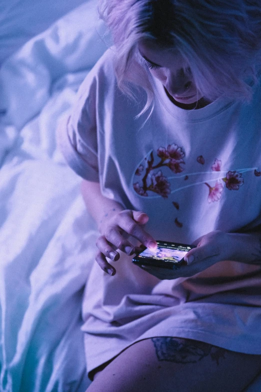 woman texting on her phone while in bed