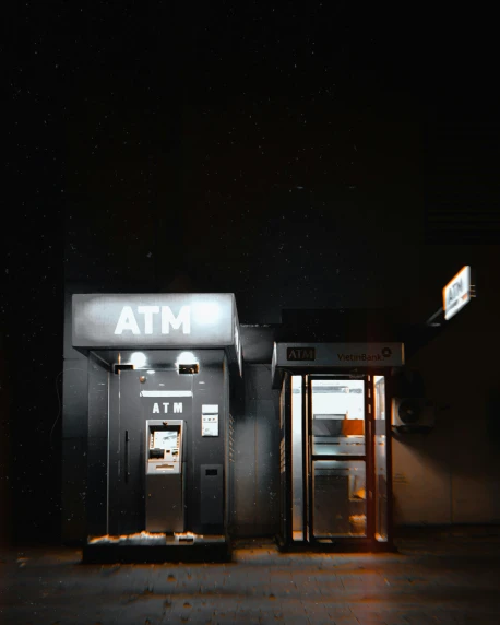 an atm machine sitting in a dark street