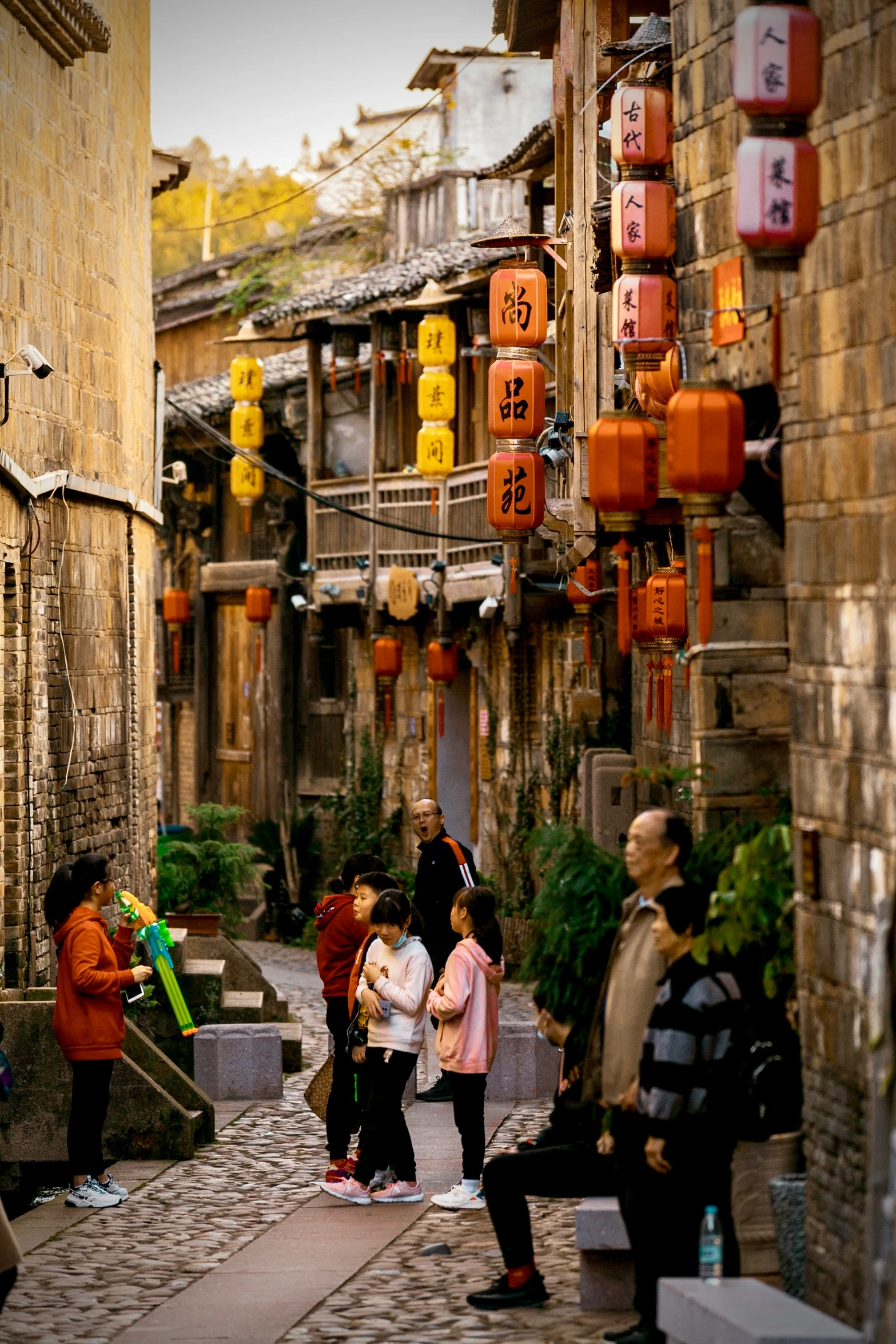 several people standing on the walkway in front of buildings