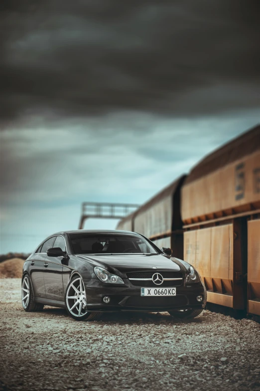 a mercedes parked in front of a train