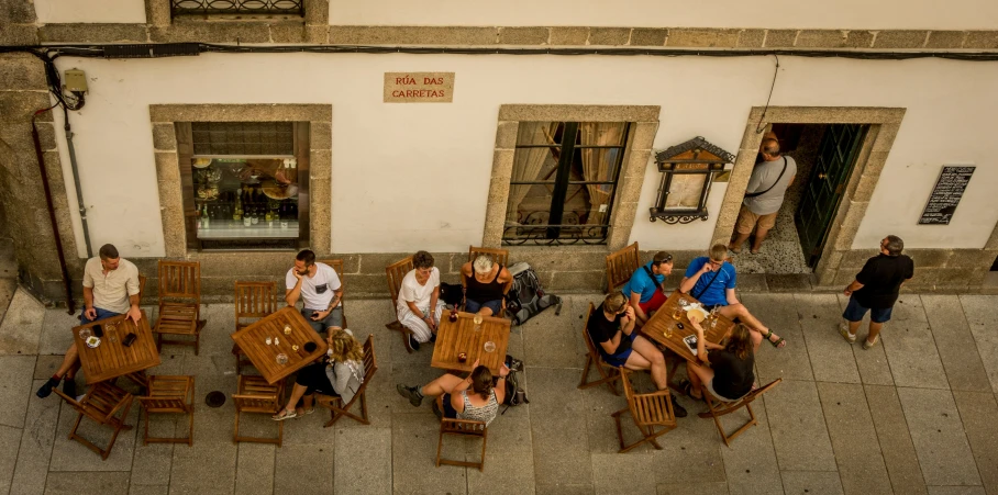 people are sitting at the tables outside eating together