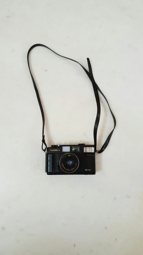 an old camera on a strap sitting on the floor