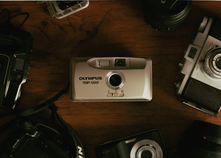 some old cameras are laying out on the table