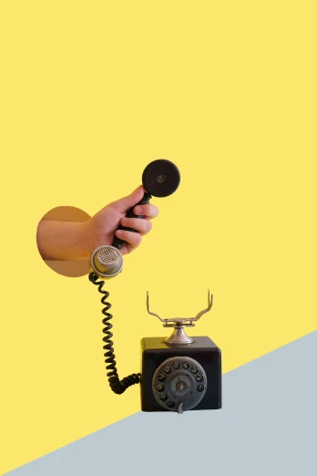 an old phone sitting in front of a yellow and blue background