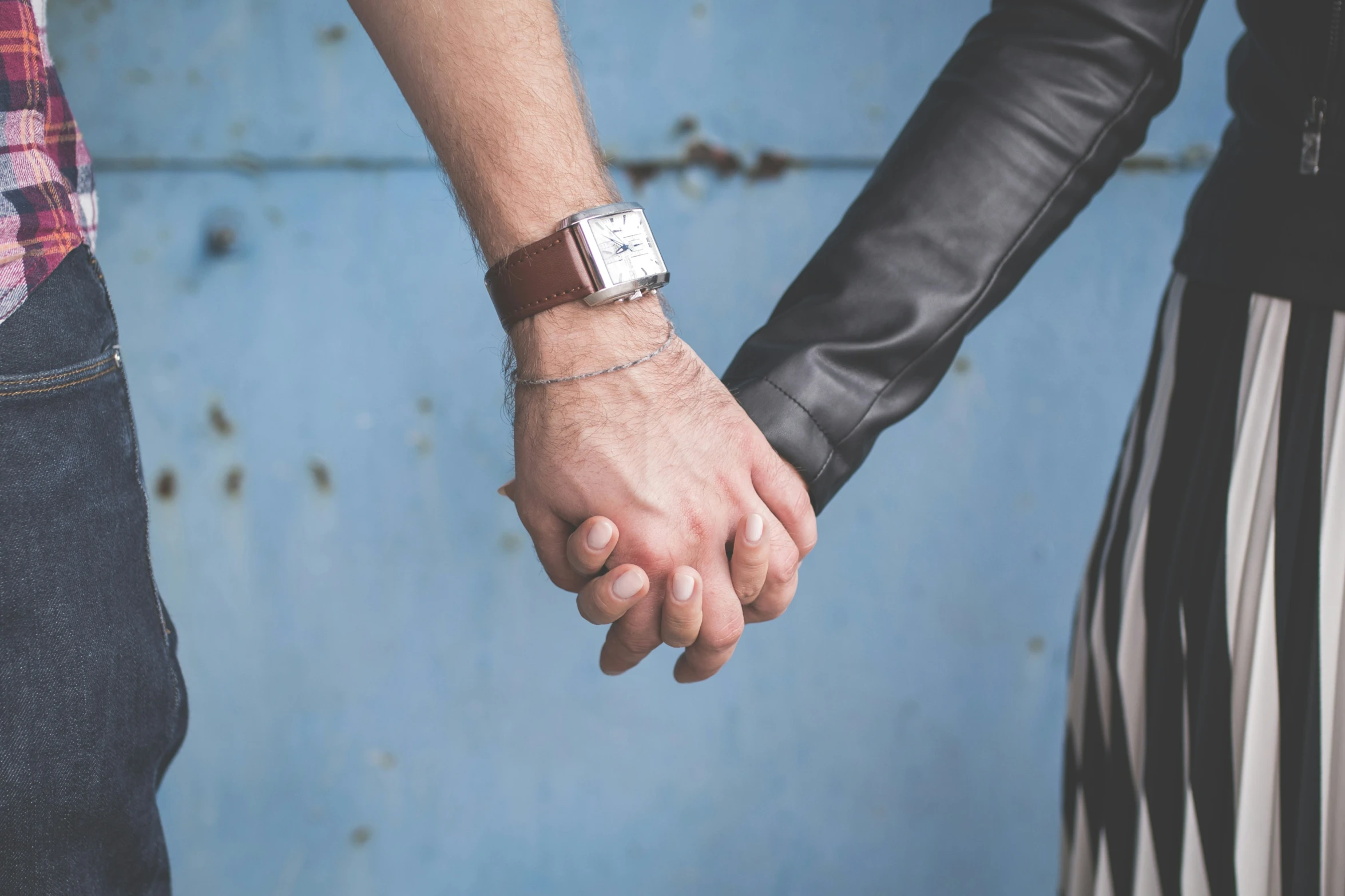 a couple holding hands and looking at each other