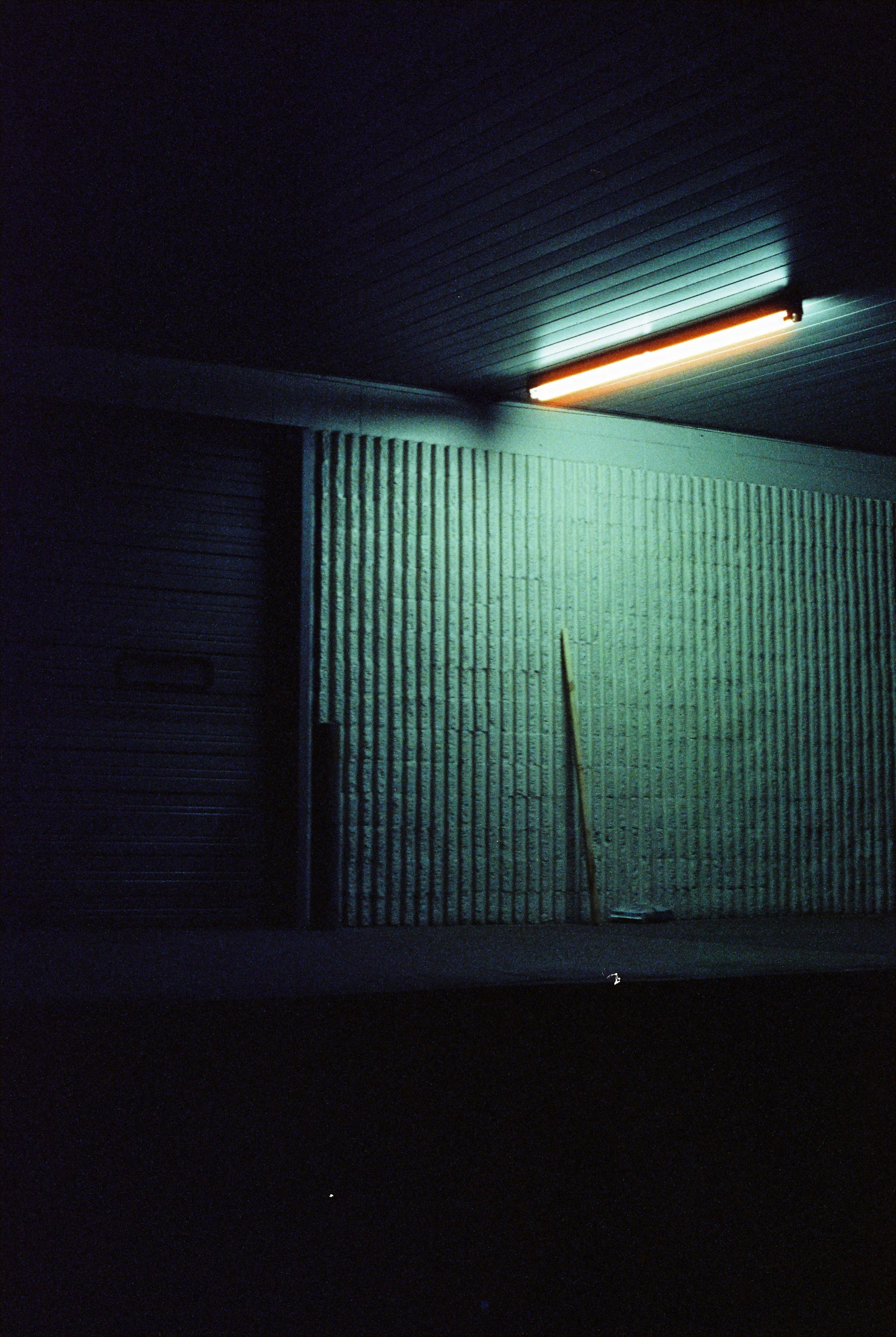 a bathroom with a toilet and some dark colors