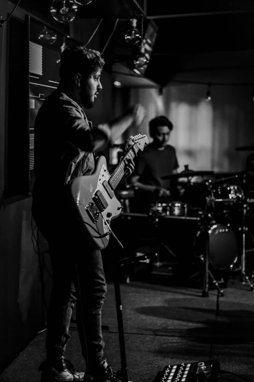 a black and white po of two men playing music