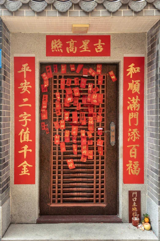 the door to this building is covered in red calligraphy