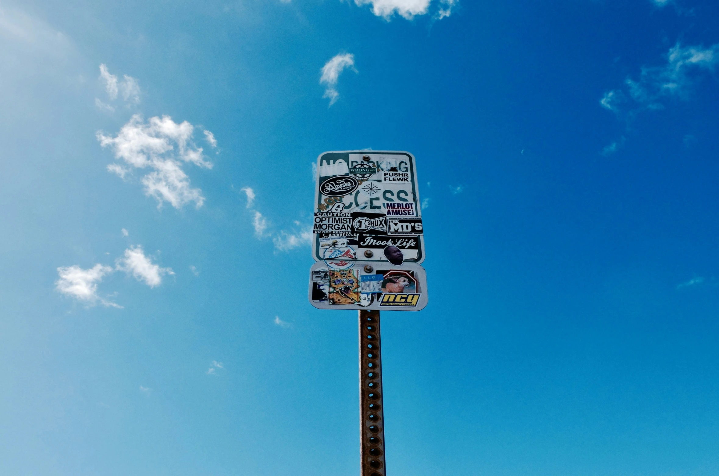 a tall metal pole that has a sign on it