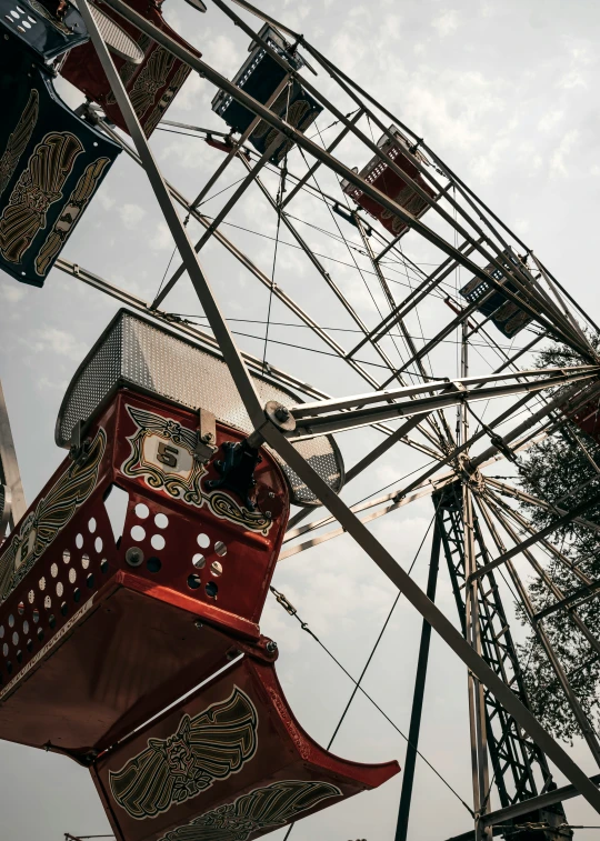 an old ferris wheel with a red cloth covering it