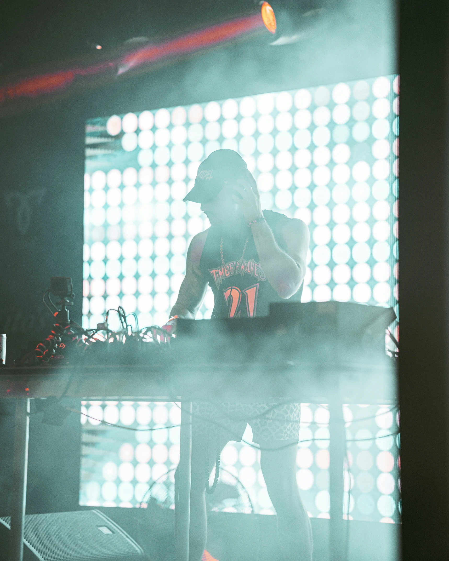 a man sitting at a dj booth during a concert