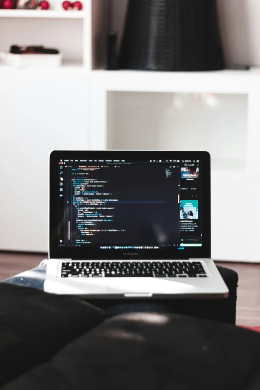 a lap top sits on a coffee table