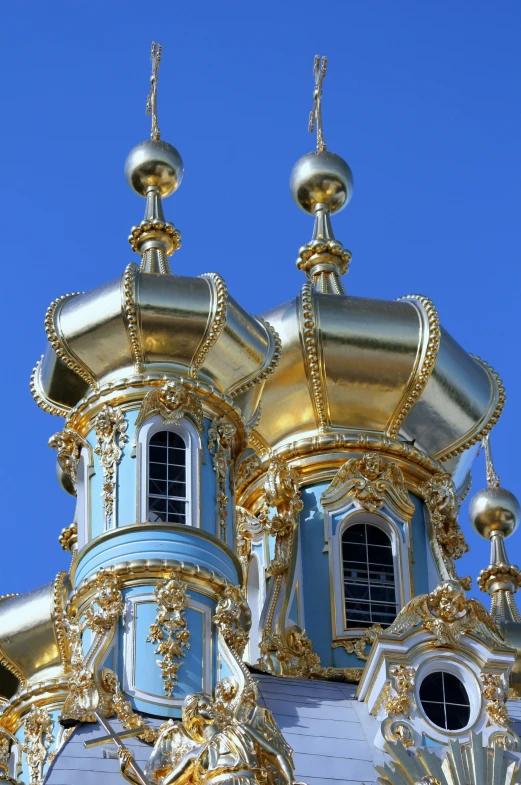 gold and blue ornate architecture against a clear sky