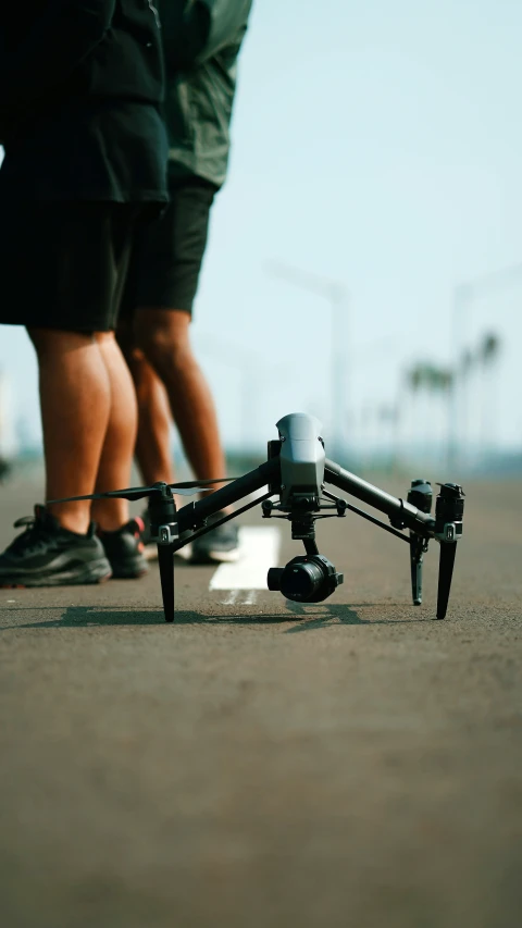 the man is next to his small remote control drone