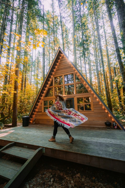 woman carrying a surfboard walking on deck towards a cabin