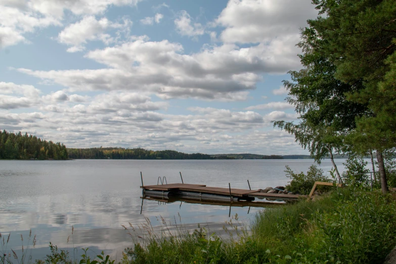 a boat on the dock at a peaceful lake