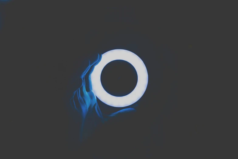 the blue circular lights is shining on a dark background