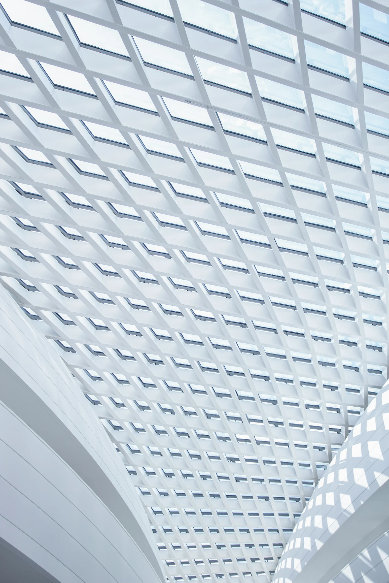 the inside of an airport building with glass roofing